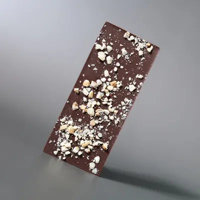 Cookies and Cream white chocolate bar on a grey seamless background