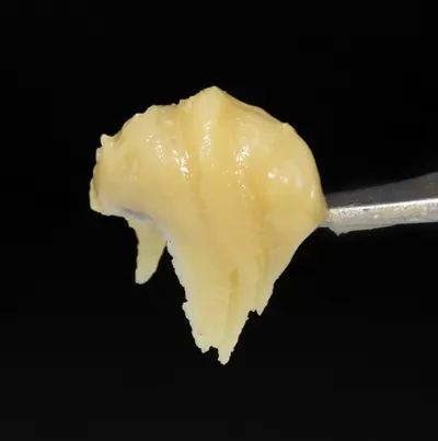 Cold-cure live rosin on a dab tool, glossy and pale gold